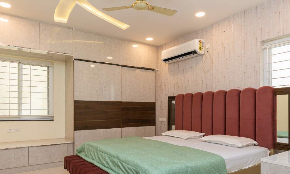 3BHK Master bedroom interior in Nizampet, Hyderabad with wardrobe and bay seating