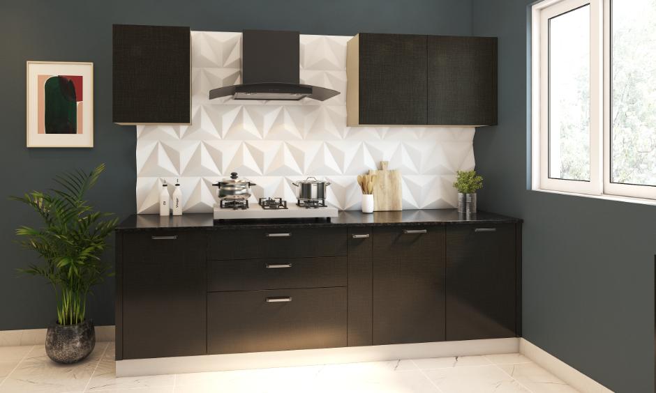 White 3D kitchen wall tiles and black cabinets under a modern chimney