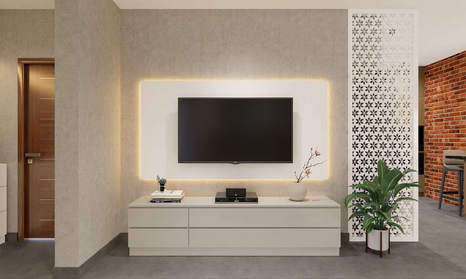 An entertainment unit with an LED-backlit wall panel and a low lying cabinet for 1bhk flat interior design