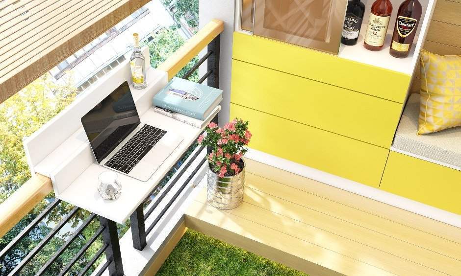 House balcony design with counter attached to railing used as a study table