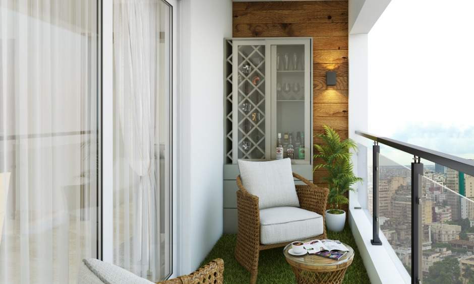 The balcony in 1bhk flat design with rattan chairs, coffee table and wine cabinet is perfect for evening get-togethers