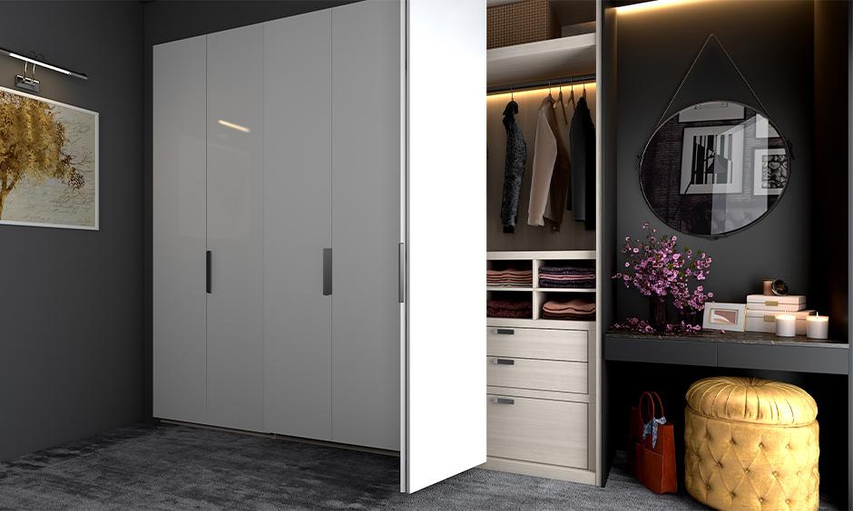 A bi-fold door wardrobe opens with hinged panels, offering wide access in a compact bedroom space.