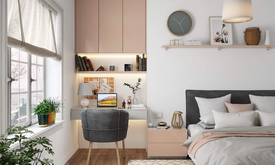 Home office setup in the bedroom with a wall-mounted desk with an open floating shelf and closed cabinets above
