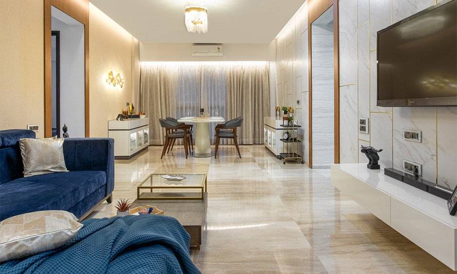 Interiors in mumbai where the living room displays a minimalistic design with a pop blue