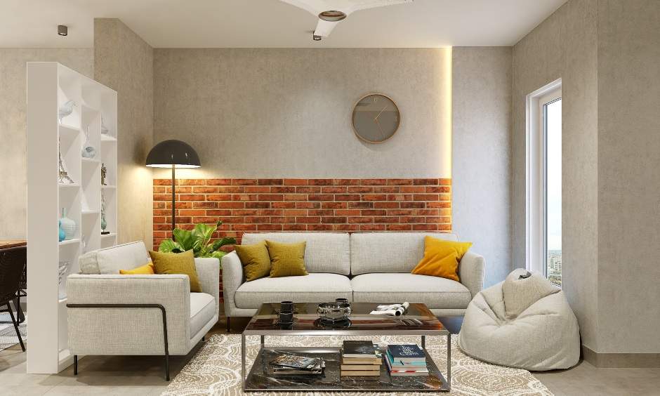 Living room home interior for 1bhk flat is designed in sandstone wallpaper and brick cladding wall; the sofa unit and a bean bag