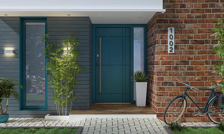 Blue main entrance door with potted plants enhancing positivity as per Vastu principles