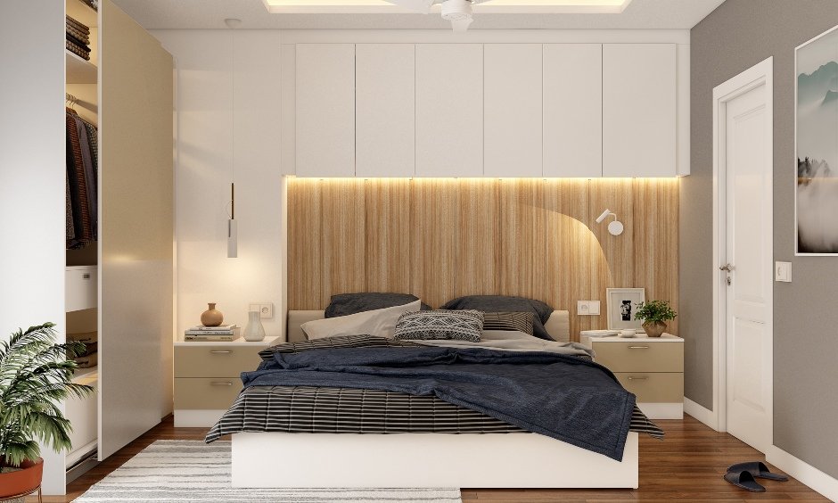 Master bedroom is designed with a king-sized bed with storage cabinets around by luxury interior designers in chennai