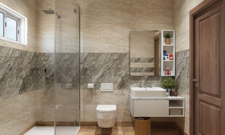 Modern 1 bhk bathroom is designed with glass partition and wall-mounted vanity