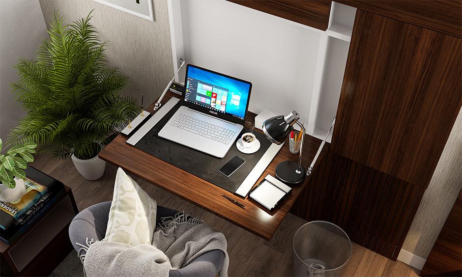 Modern small home office with a fold-out desk, cosy chair, and space-saving minimalist design.