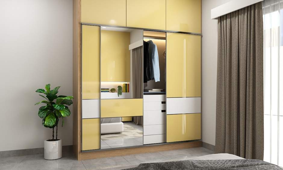 The wall cabinet behind the bed and modular wardrobe provide additional storage space in a 2bhk house interior design