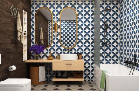 Moroccan bathroom design with mosaic tiles, arched mirror, and golden fixtures