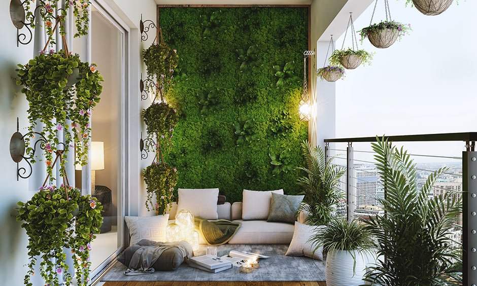 Small balcony designs having lush plants, flower pots, a grass wall to add a touch of nature