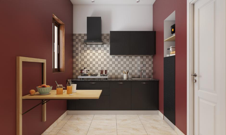 Normal kitchen design with black cabinets, wall-mounted foldable table and tiled backsplash