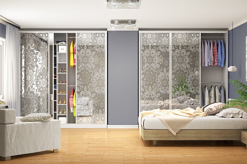 Patterned glass door wardrobe design is uniquely designed and divided into separate sections with a wall divider