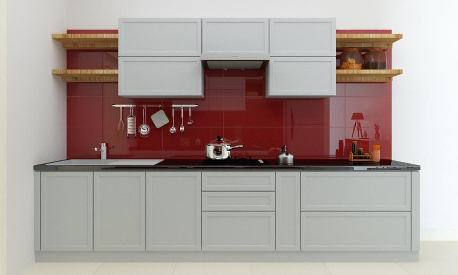 Bold red back-painted glass backsplash adding a striking touch to the kitchen