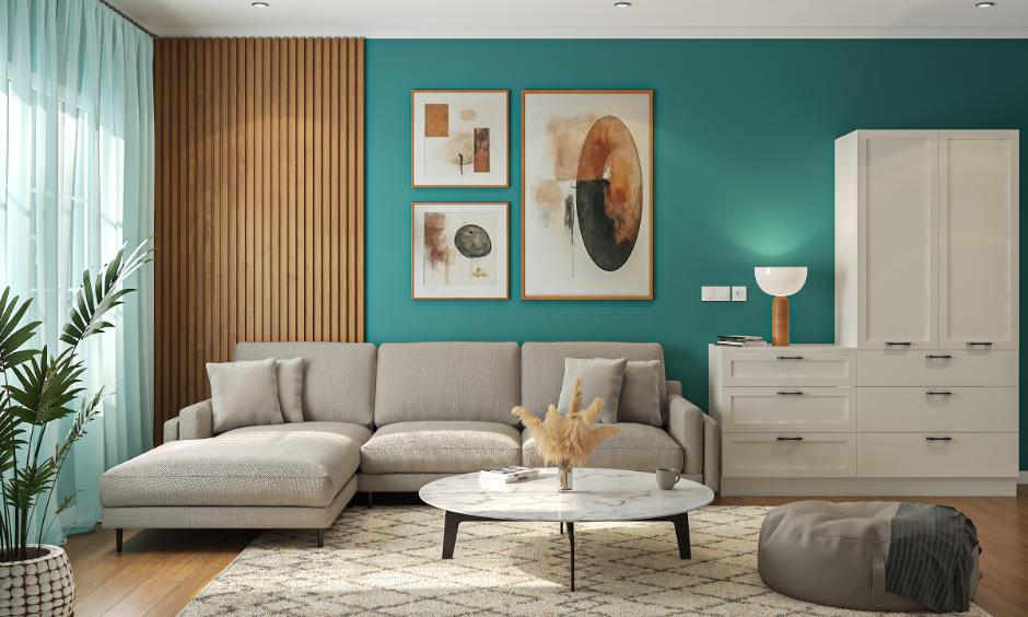 Living room with teal wall colour design, wooden panel, and beige sofa for a stylish home wall colour design