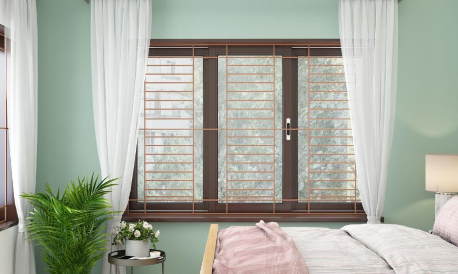 Contemporary bedroom with brown grill colour design and pastel green wall for a fresh home look.